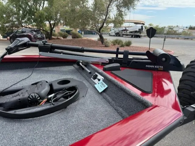 Slide: The Image of 2025 Tracker Pro Team 175 boat with Minn Kota trolling motor in a parking lot. - 6