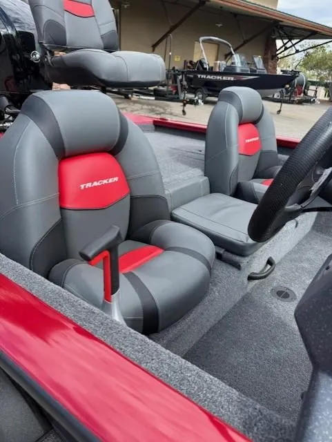 Slide: The Image of 2025 Tracker Pro Team 175 boat interior with red and gray seats. - 7