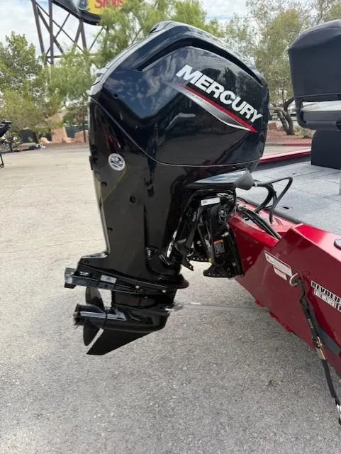 Slide: The Image of 2025 Tracker Pro Team 175 with Mercury outboard motor, parked outdoors. - 9
