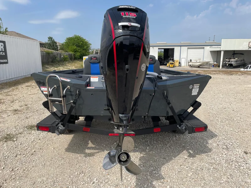 Slide: The Image of 2025 Ranger RT188P boat with Mercury 115 outboard motor, parked on gravel. - 2