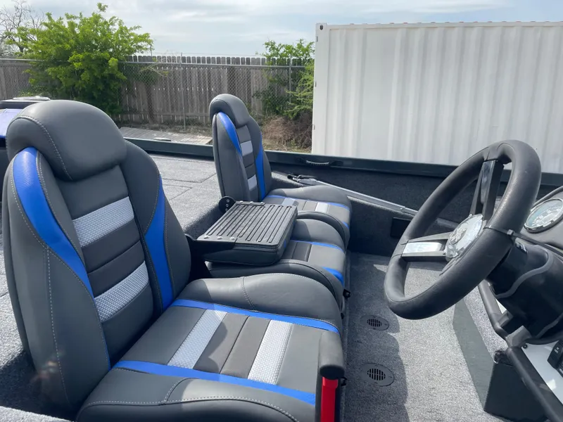 Slide: The Image of 2025 Ranger RT188P boat interior with blue and gray seats, steering wheel, and console. - 7