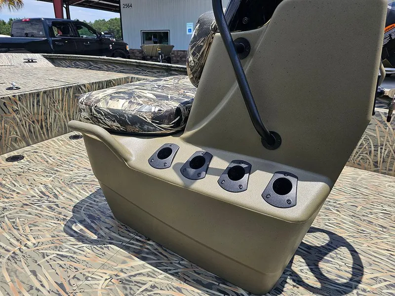Slide: The Image of 2025 Tracker Grizzly 1860 CC boat console with camo seat and rod holders. - 11