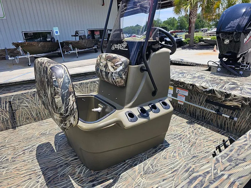 Slide: The Image of 2025 Tracker Grizzly 1860 CC boat interior with camo seats and steering console. - 12