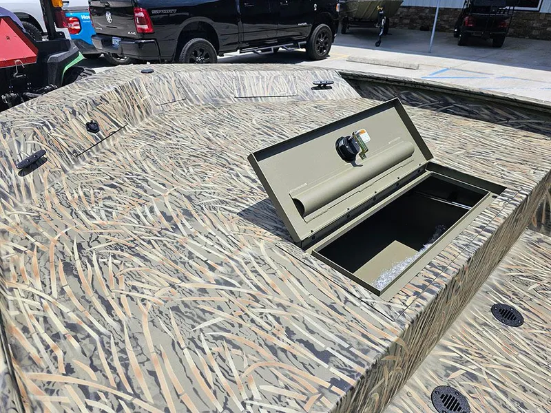 Slide: The Image of 2025 Tracker Grizzly 1860 CC boat with camo pattern and open storage compartment. - 14