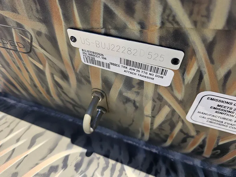 Slide: The Image of 2025 Tracker Grizzly 1860 CC boat hull identification number and camouflage pattern detail. - 18