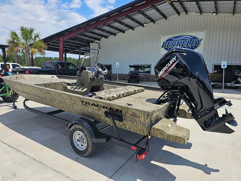 Slide: The Image of 2025 Tracker Grizzly 1860 CC boat with Mercury engine on trailer, parked outdoors. - 3