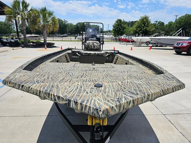 Slide: The Image of 2025 Tracker Grizzly 1860 CC boat with camouflage design in outdoor setting. - 4