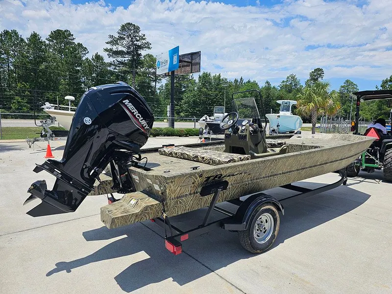 Slide: The Image of 2025 Tracker Grizzly 1860 CC boat on trailer with Mercury outboard motor, parked outdoors. - 7