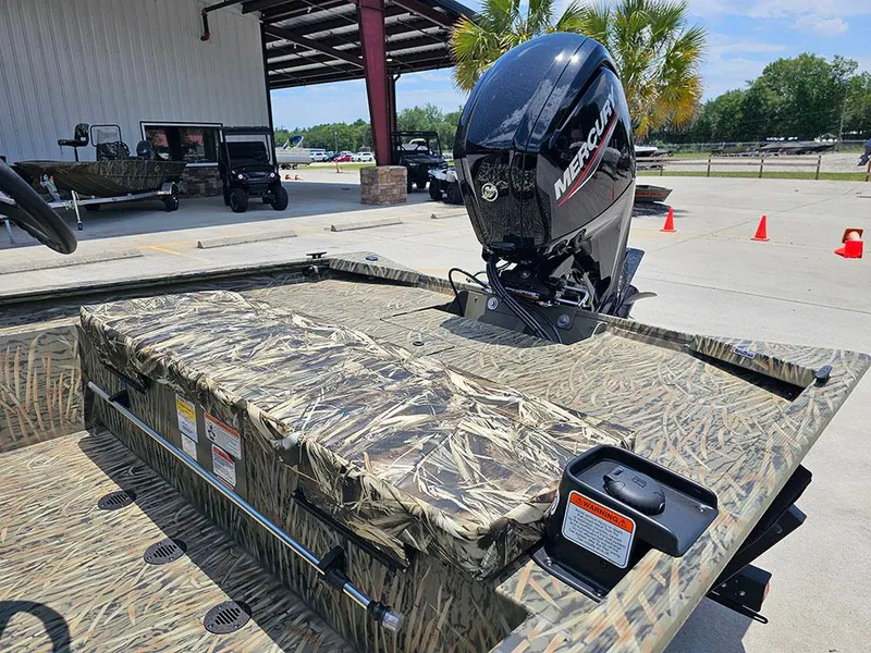 Slide: The Image of 2025 Tracker Grizzly 1860 CC boat with camo design and Mercury outboard motor. - 9
