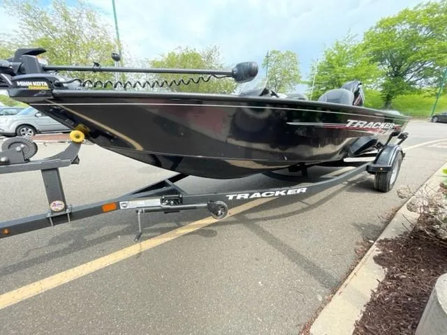Slide: The Image of 2025 Tracker Super Guide V-16 SC boat on trailer, parked outdoors. - 2