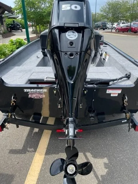 Slide: The Image of 2025 Tracker Super Guide V-16 SC boat with 50 HP motor, parked outdoors. - 3