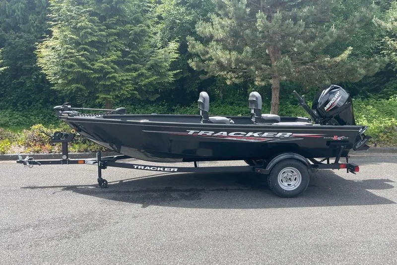 The Image of 2025 Tracker Super Guide V-16 T boat on trailer, parked outdoors. - 0
