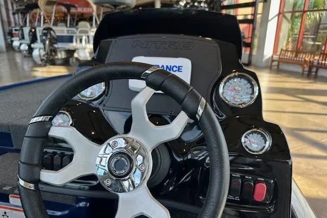 Slide: The Image of Steering wheel and dashboard of 2025 Nitro Z17 boat, featuring gauges and controls. - 4
