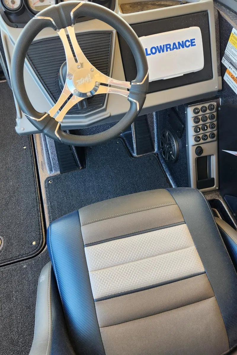 Slide: The Image of 2024 Ranger 1850MS boat interior with steering wheel and Lowrance display. - 4
