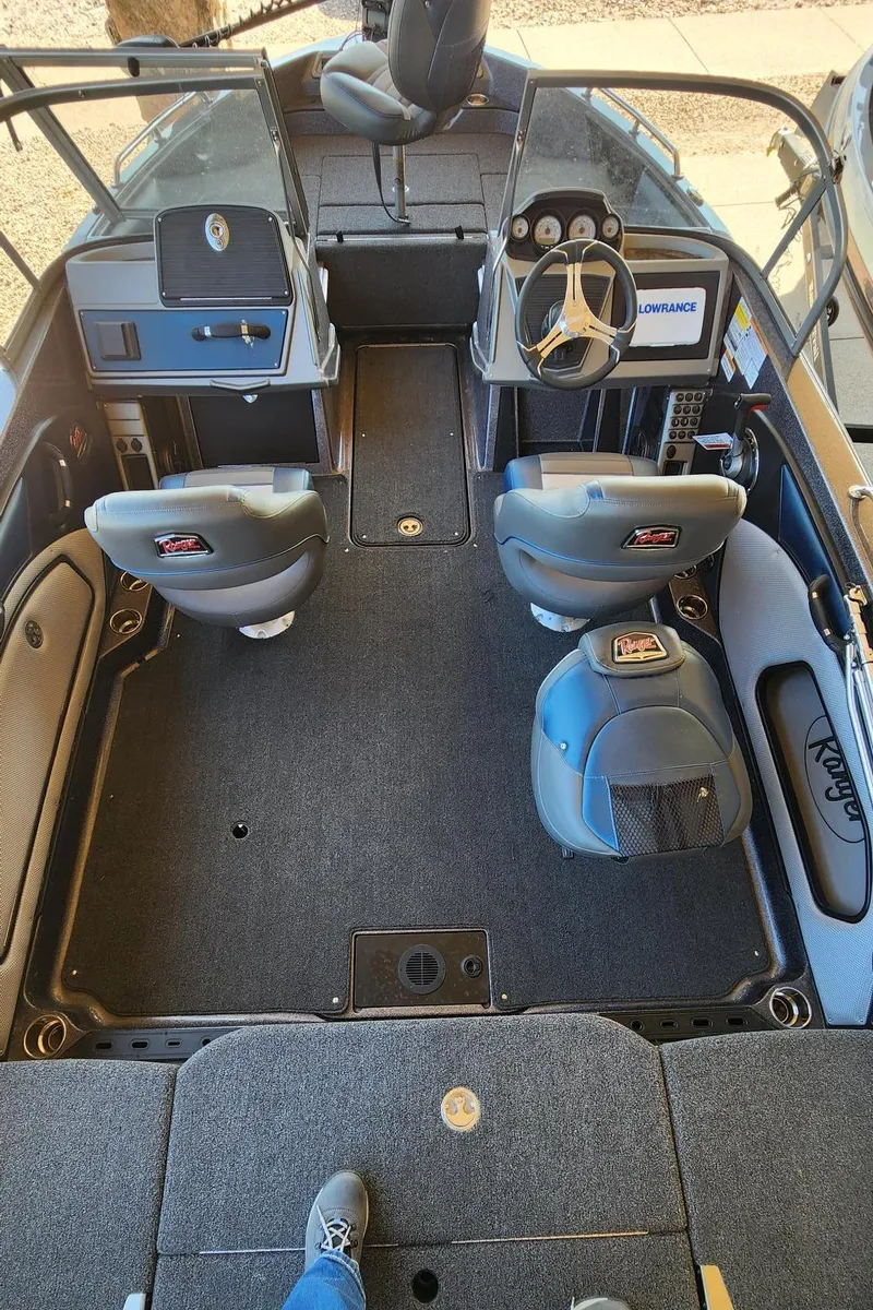 Slide: The Image of 2024 Ranger 1850MS boat interior with dual consoles, seating, and carpeted flooring. - 6