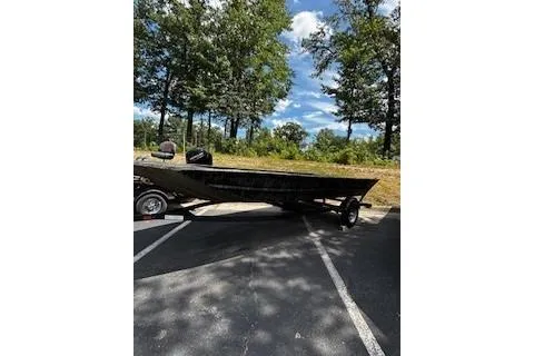 The Image of 2025 Tracker Grizzly 1860 Utility boat parked outdoors on a sunny day. - 0