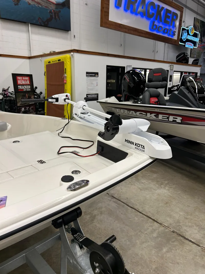 Slide: The Image of 2025 Mako Pro Skiff 15 CC with Minn Kota Maxxum motor in showroom. - 3