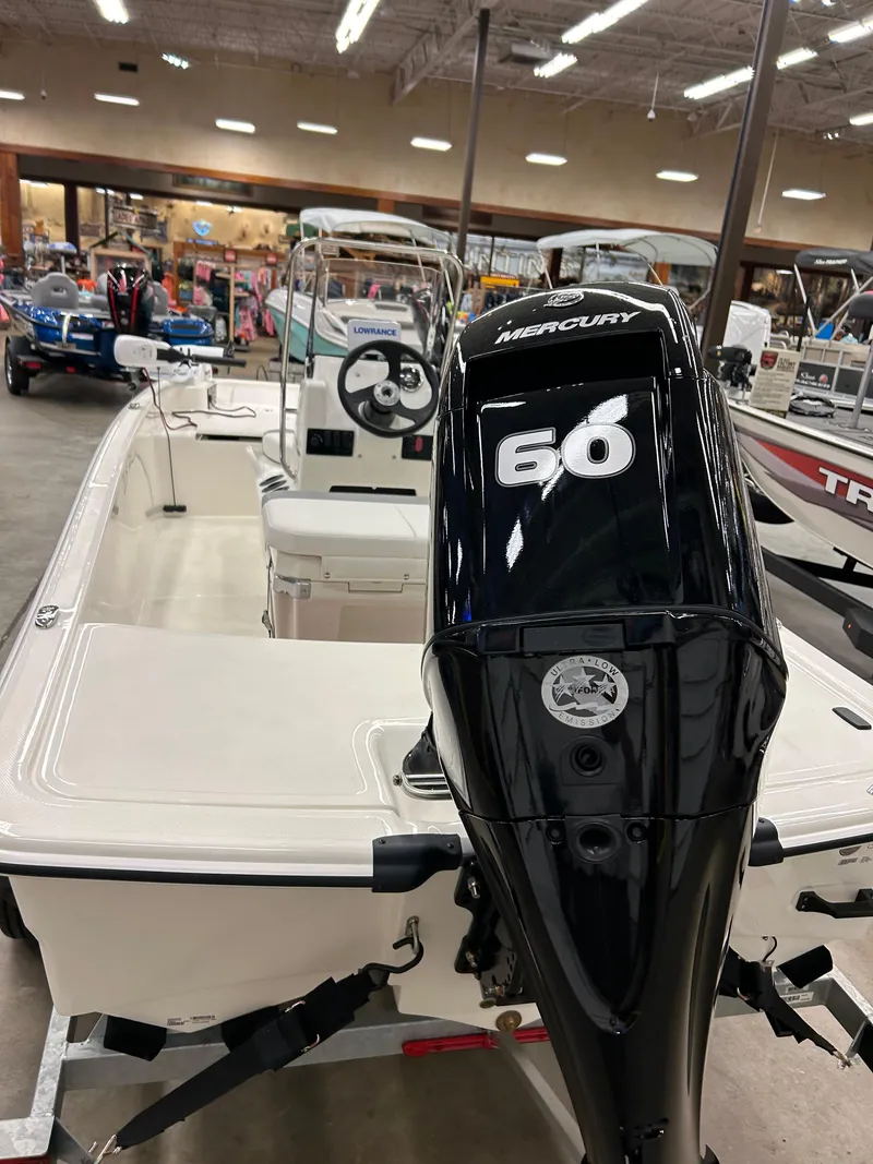 Slide: The Image of 2025 Mako Pro Skiff 15 CC with Mercury 60 engine in showroom. - 5