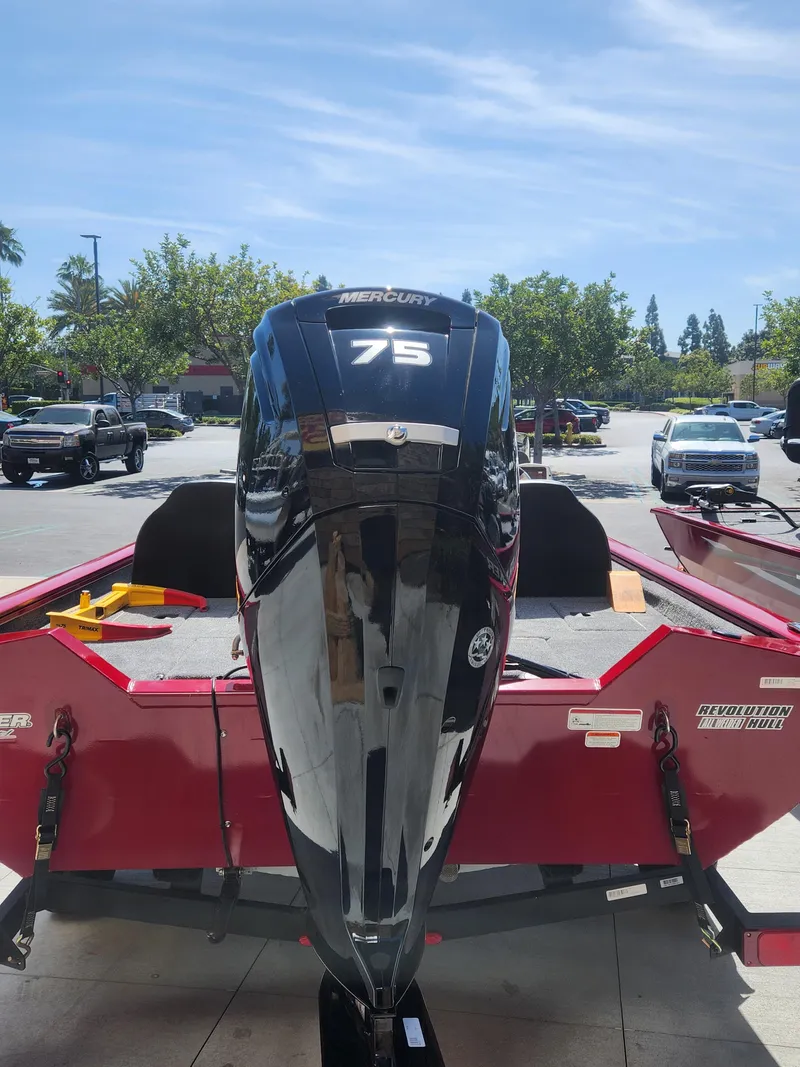Slide: The Image of 2025 Tracker Pro Team 175 boat with Mercury 75 engine, parked outdoors. - 2