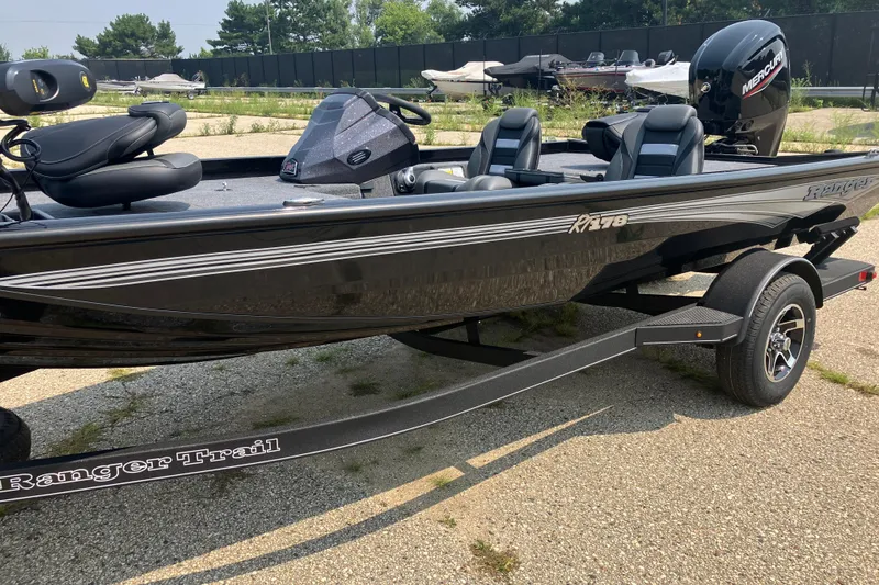 Slide: The Image of 2025 Ranger RT178 boat on trailer, black exterior, parked outdoors. - 2