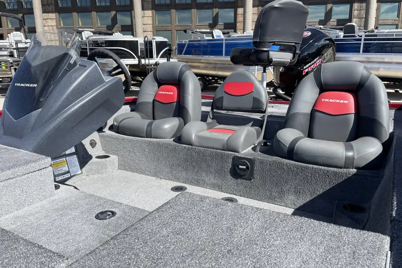 Slide: The Image of 2025 Tracker Savage 215 boat interior with gray and red seating. - 3