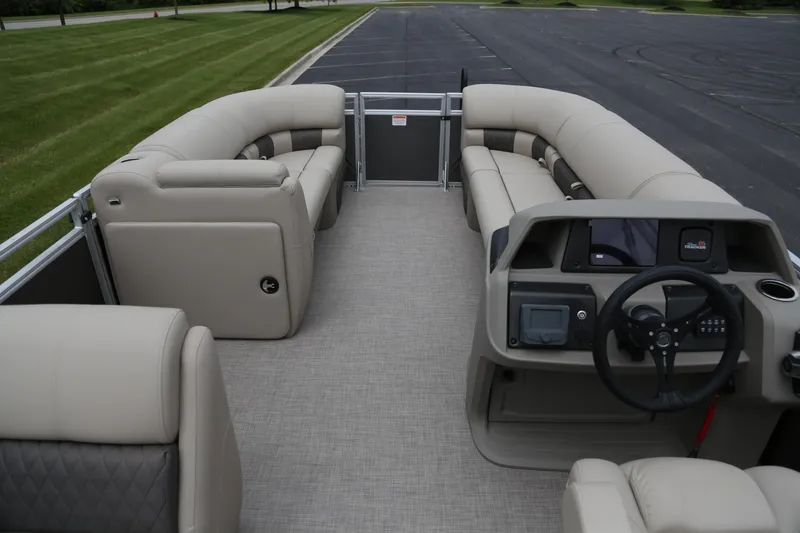 Slide: The Image of 2025 Sun Tracker Party Barge 20 DLX interior with plush seating and modern dashboard. - 5