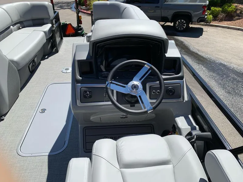 Slide: The Image of 2025 Regency 230 LE3 boat interior with steering wheel and seating. - 4