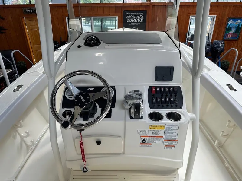 Slide: The Image of 2025 Mako 214 CC boat console with steering wheel and control panel. - 11