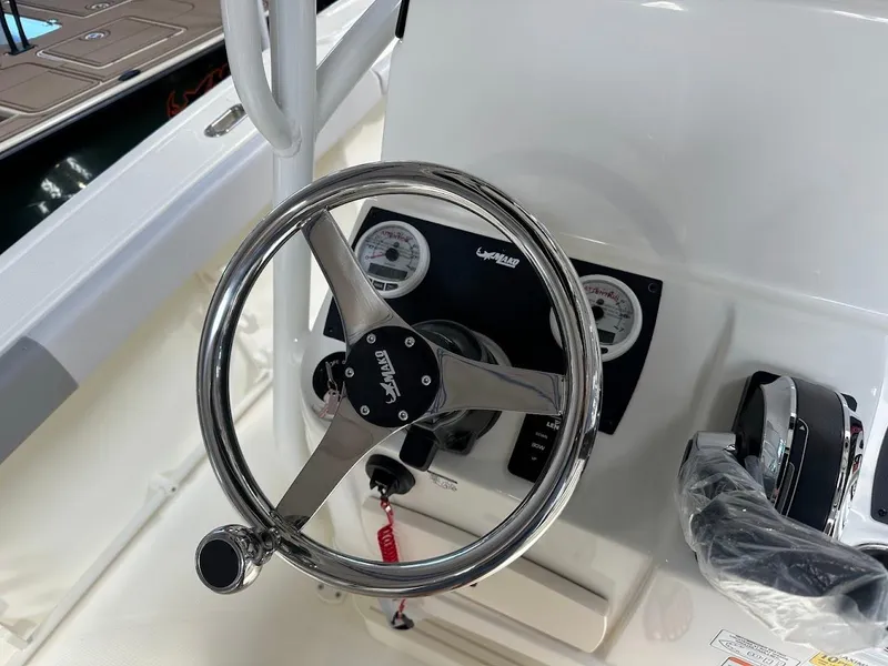 Slide: The Image of Steering wheel and controls of 2025 Mako 214 CC boat. - 12