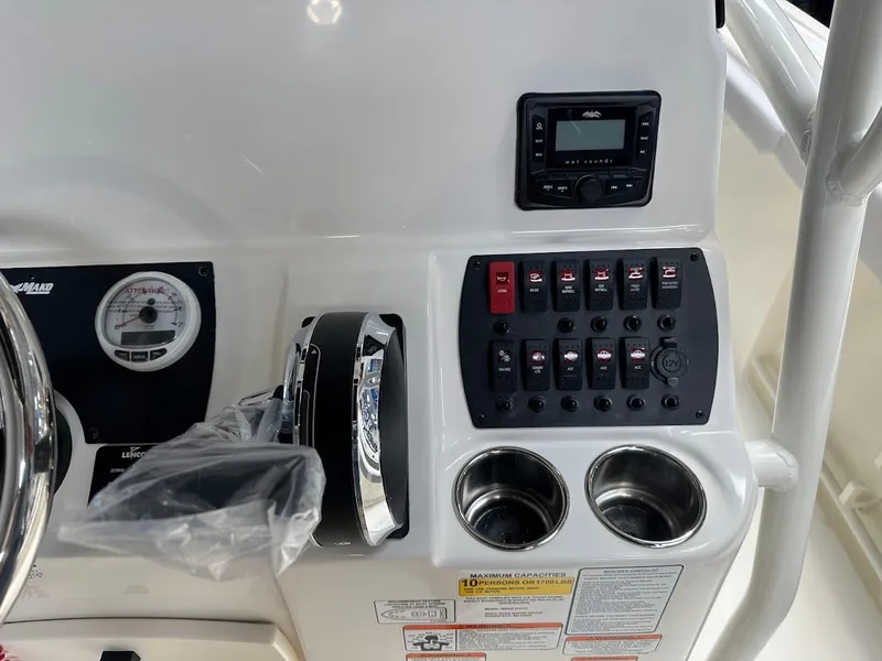 Slide: The Image of Control panel of 2025 Mako 214 CC boat with switches and gauges. - 13