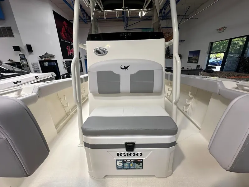 Slide: The Image of 2025 Mako 214 CC boat interior with Igloo cooler seat in showroom. - 15