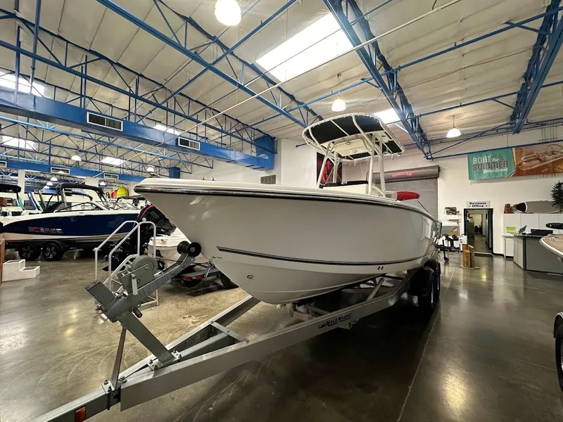 Slide: The Image of 2025 Mako 214 CC boat displayed indoors on a trailer. - 3