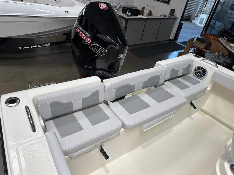 Slide: The Image of 2025 Mako 214 CC boat interior with cushioned seating and Mercury Pro XS engine. - 8