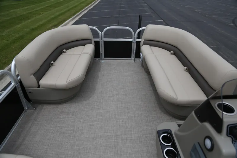Slide: The Image of 2025 Sun Tracker Party Barge 16 DLX interior with beige seating and cup holders. - 4