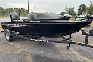 The Image of 2025 Tracker Super Guide V-16 T boat on trailer, parked outdoors. - 0