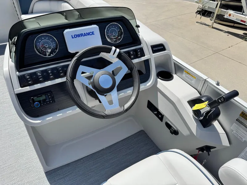 Slide: The Image of 2025 Godfrey Sweetwater 2086 SB boat dashboard with steering wheel and controls. - 14