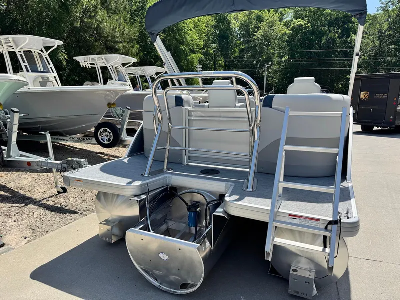 Slide: The Image of 2025 Godfrey Sweetwater 2086 SB pontoon boat with ladder, docked outdoors. - 4