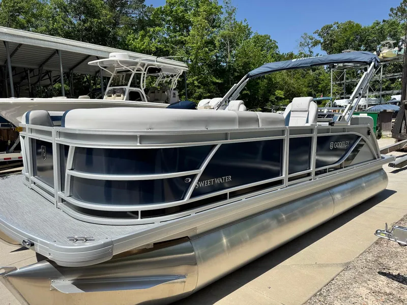 Slide: The Image of 2025 Godfrey Sweetwater 2086 SB pontoon boat docked, featuring sleek design and comfortable seating. - 6