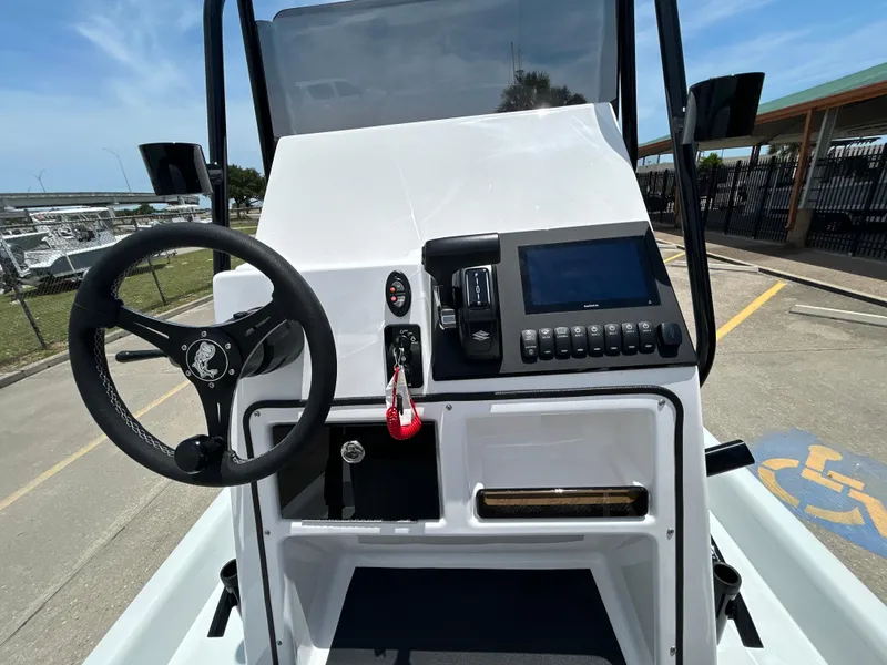 Slide: The Image of 2025 Shallow Stalker CAT 211 PRO boat console with steering wheel and control panel. - 13