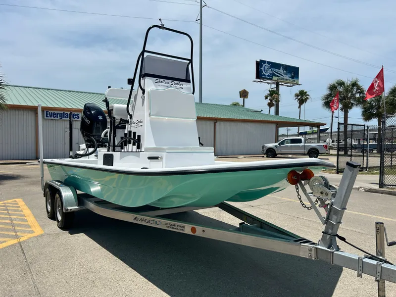 Slide: The Image of 2025 Shallow Stalker CAT 211 PRO boat on trailer, parked outdoors. - 4