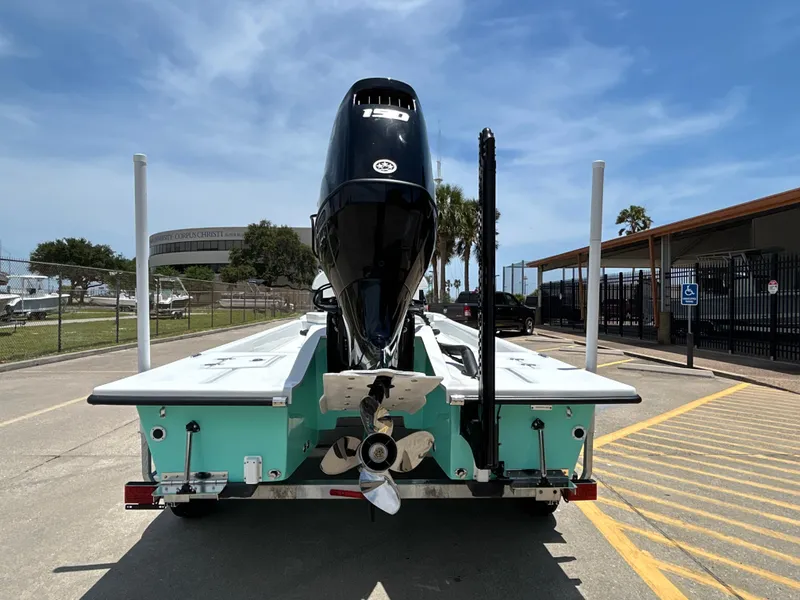 Slide: The Image of Shallow Stalker CAT 211 PRO 2025 boat, rear view, parked on a sunny day. - 7