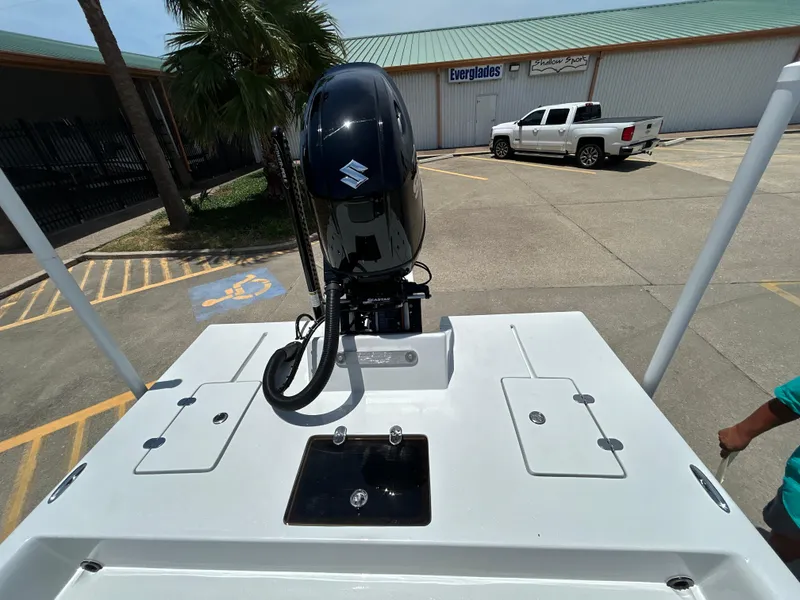 Slide: The Image of 2025 Shallow Stalker CAT 211 PRO boat with Suzuki outboard motor in parking lot. - 8