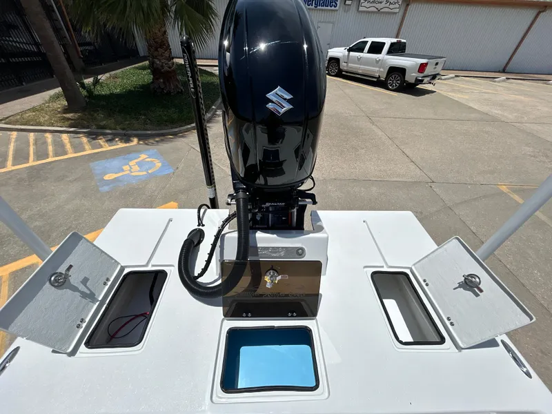 Slide: The Image of 2025 Shallow Stalker CAT 211 PRO boat with Suzuki outboard motor in parking lot. - 9