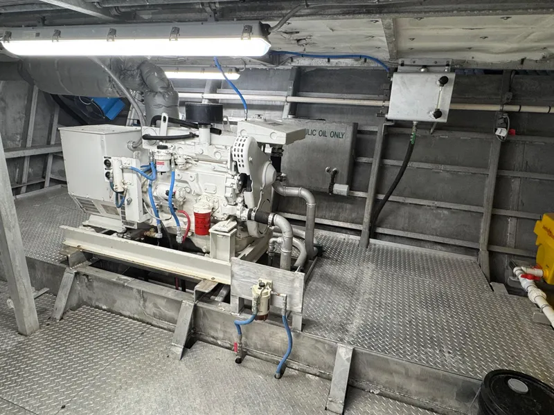 Slide: The Image of Engine room of a 1985 custom houseboat with visible machinery and piping. - 16