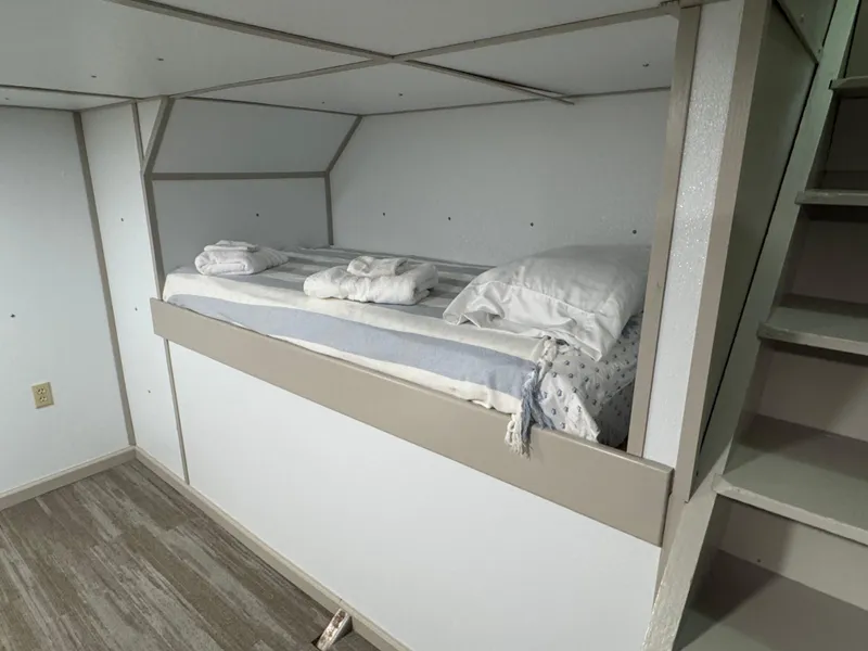Slide: The Image of Compact bunk bed in a 1985 custom houseboat interior with minimalist design. - 17