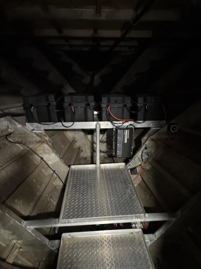 Slide: The Image of Interior of a 1985 custom houseboat showing battery storage and metal walkway. - 19