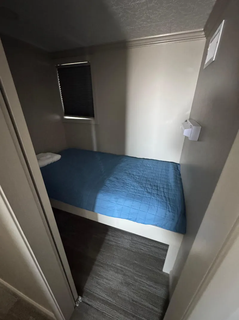 Slide: The Image of Small bedroom with a single bed in a 1985 custom houseboat. - 29