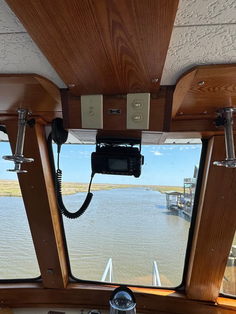 Slide: The Image of Interior view from a 1985 custom houseboat, showing the helm and waterway. - 33
