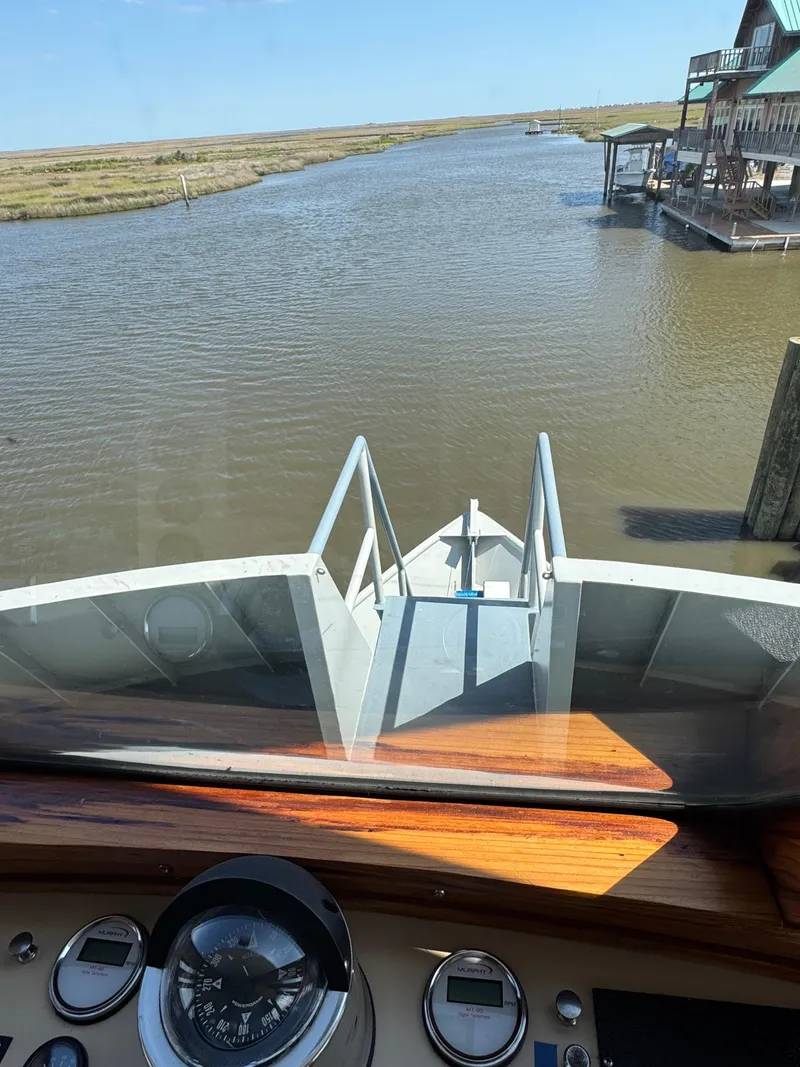 Slide: The Image of View from 1985 Custom House Boat navigating a calm river. - 37