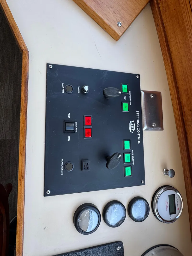 Slide: The Image of Control panel of a 1985 Custom House Boat with gauges and switches. - 38